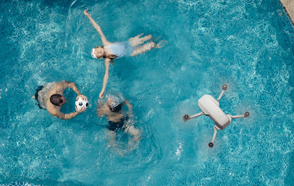 dji mavic mini drone over pool
